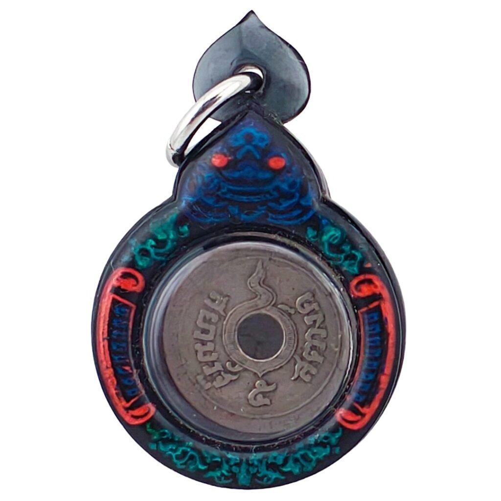 Close-up of 100-year burial corpse coin amulet from Ajarn Tom, early 1900s Thai coin with Chakra mark used for wealth and luck