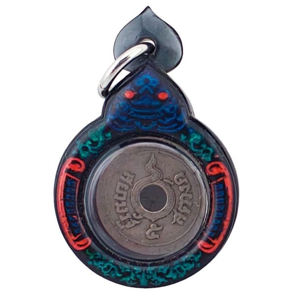 Close-up of 100-year burial corpse coin amulet from Ajarn Tom, early 1900s Thai coin with Chakra mark used for wealth and luck