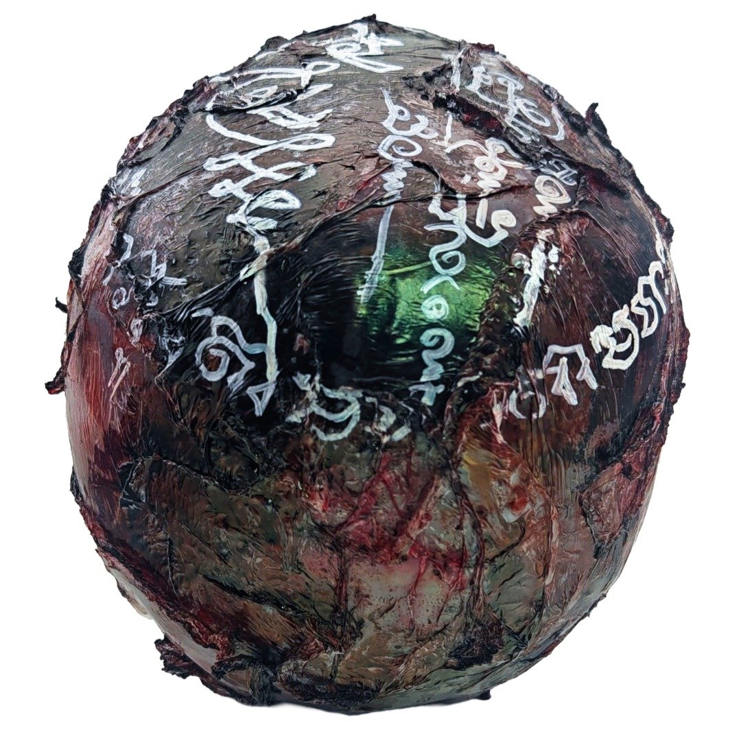 Angled top view of the Ritual Prai Skull showing white yants, dark ritual finish and weathered skull texture.