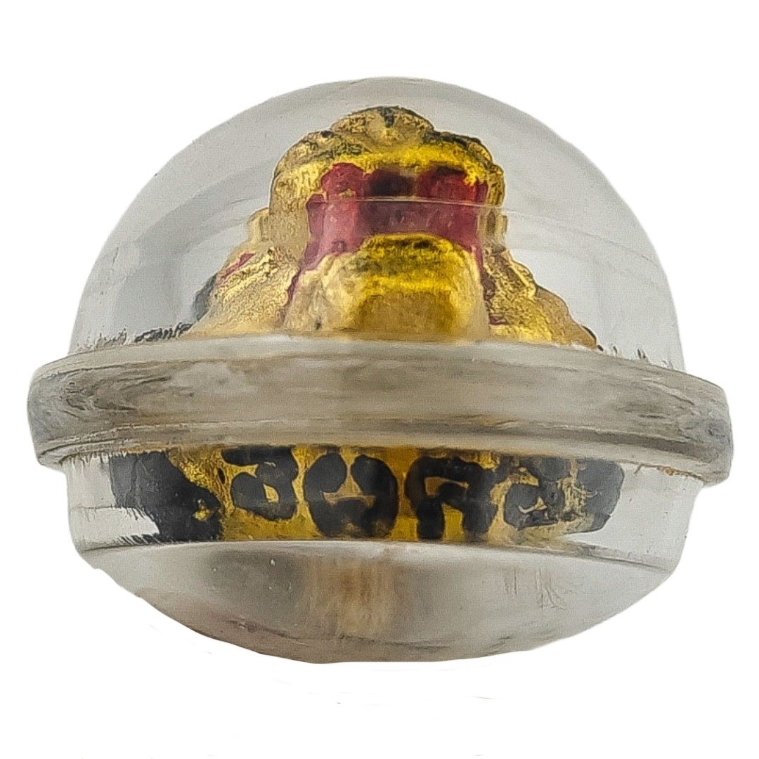 Bottom view of Lersi Sermingpai Sian by Ajarn Wanchai showing yants around the base and the tiger face inside the casing.