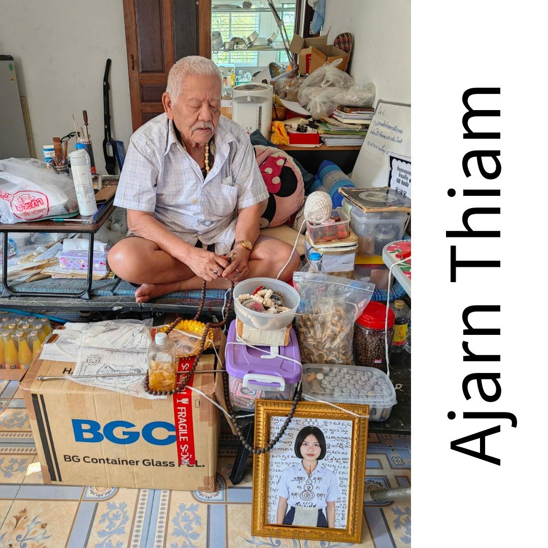 Nong Phet Wanisa batch receiving co-blessing by Ajarn Thiam with framed photo, lockets, oil bottles and ritual items