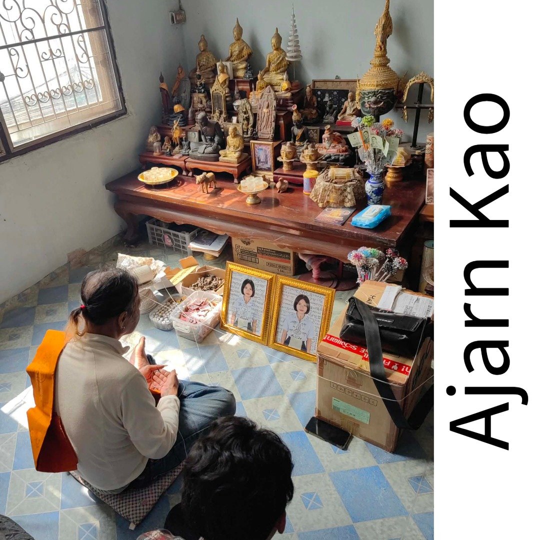 Nong Phet Wanisa batch receiving co-blessing by Ajarn Kao with framed photos, lockets and oil bottles before the altar