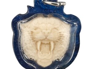 Suea Nga Chang amulet by Ajarn Wanchai BE 2568, front view showing tiger face with fangs in blue casing