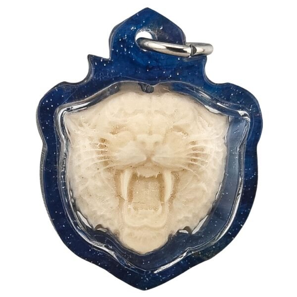 Suea Nga Chang amulet by Ajarn Wanchai BE 2568, front view showing tiger face with fangs in blue casing