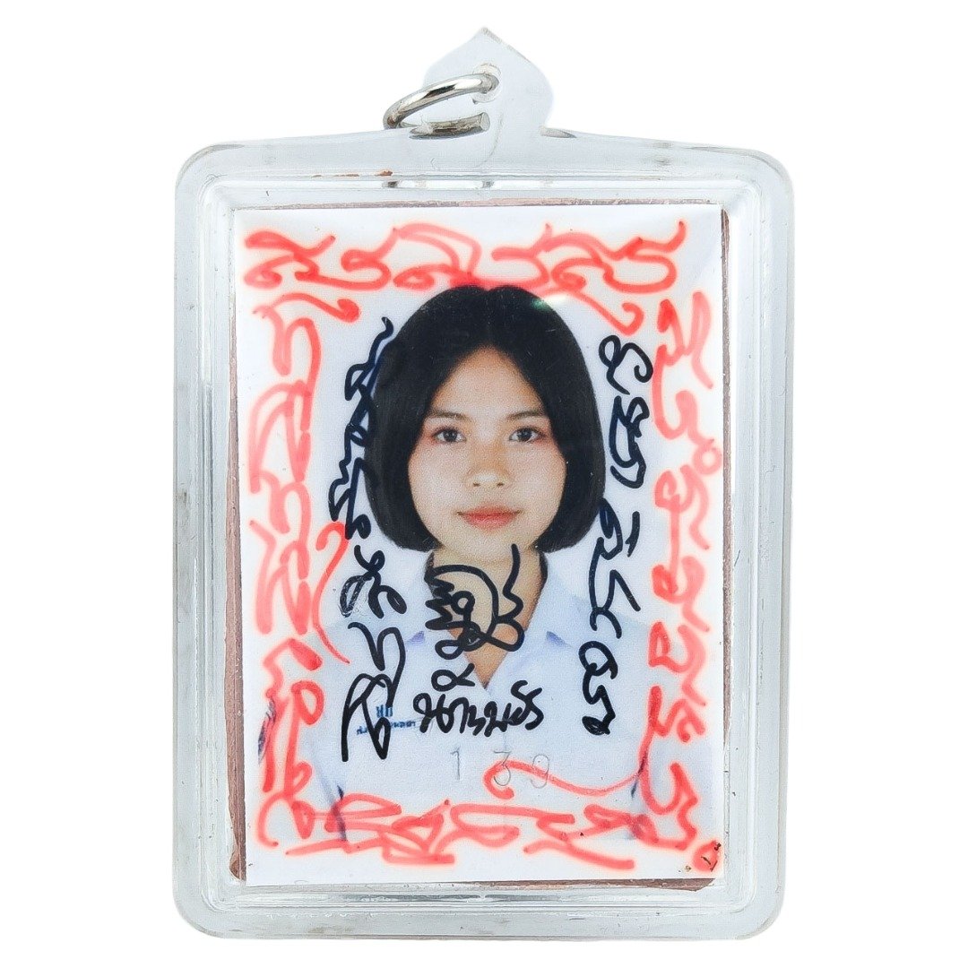 Front view of Nong Phet Wanisa locket with portrait, yant writing and clear protective casing