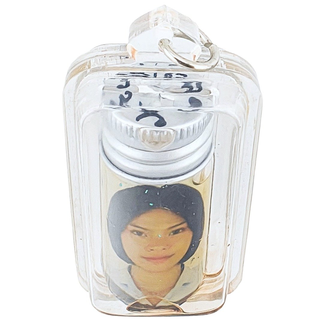 Angled front view of Nong Phet Wanisa Nam Man Prai oil bottle inside clear protective casing