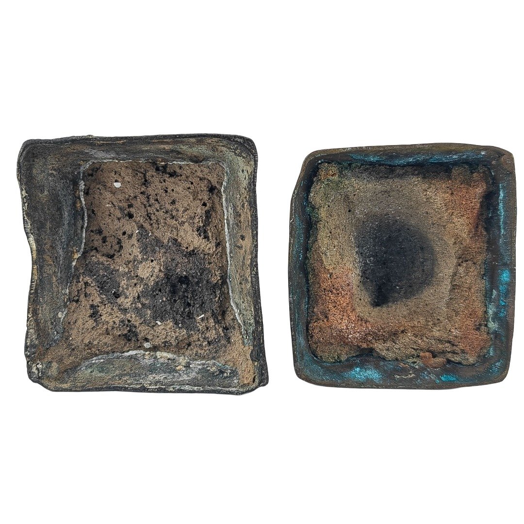 Underside of Kruba Thep’s old pair of Nang Kwak showing the hollow cast bases and natural ageing