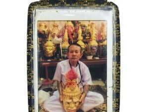 Front of the Ajarn Rut Memorial Roop Tai by Ajarn Nut, showing Ajarn Rut seated among traditional ritual masks.