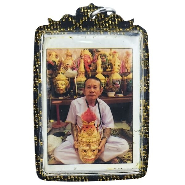 Front of the Ajarn Rut Memorial Roop Tai by Ajarn Nut, showing Ajarn Rut seated among traditional ritual masks.