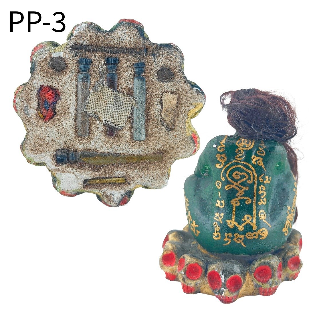 Rear and underside view of Phi Pong Bucha PP-3, showing the gold yant and individually arranged occult materials beneath the base.