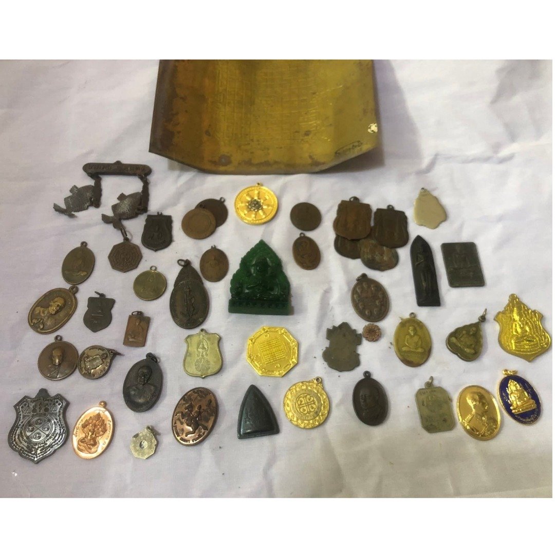 Collection of old metal amulets prepared for melting into the Nur Chanuan body of Khun Paen Saneh Nuea Duang