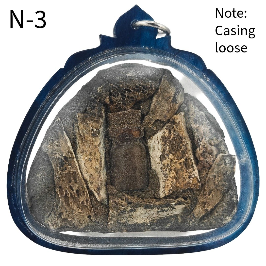 Back of Nine-Tail Fox Nong Prai Panneng N-3 by Ajarn Tom showing Panneng, prai relics and murn sarn materials; casing is loose.