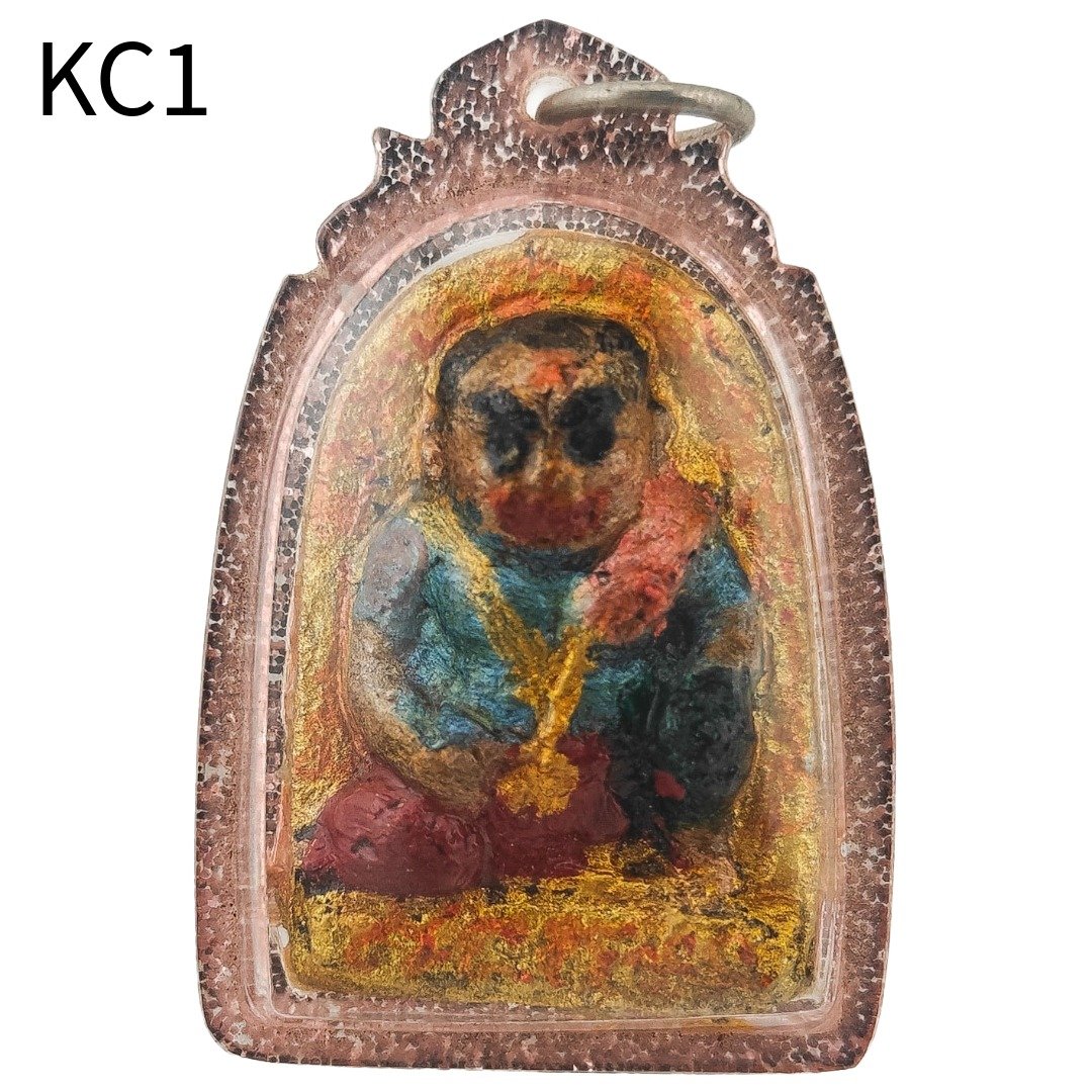 Front view of the Khun Chang wealth amulet by Ajarn Wanchai, estimated BE 2554, housed in a waterproof casing.
