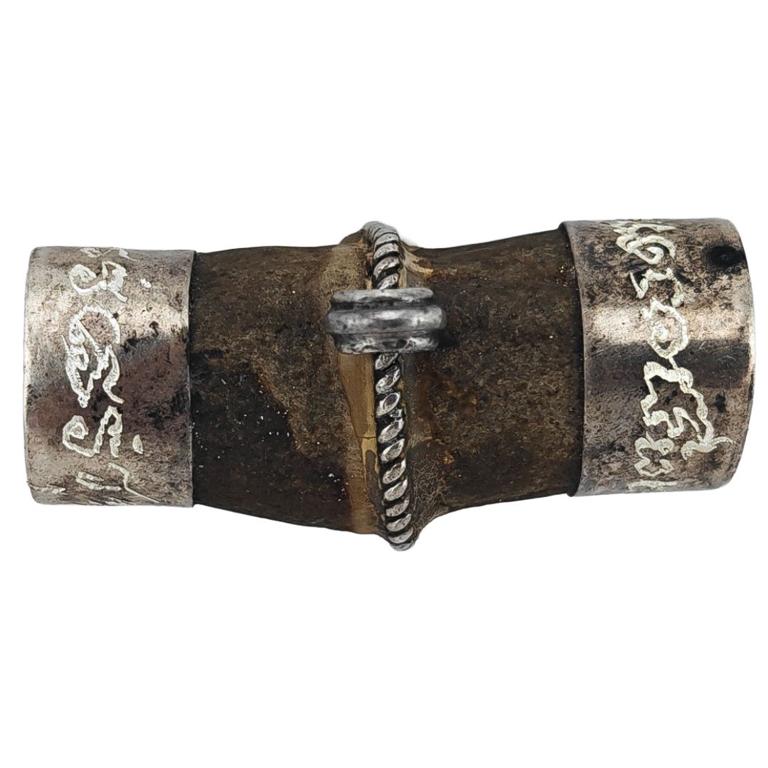 Reverse view of the old Bird’s Golden Pillow showing its natural material, central silver binding and hand-yanted silver casing