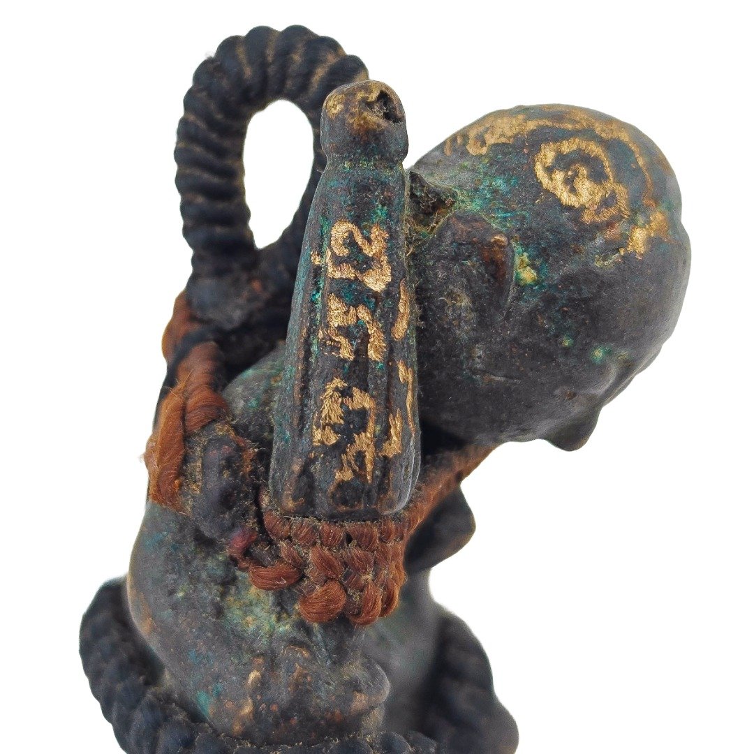 Close-up of Phra Upakut folded umbrella with hand-engraved yants and old Samrit patina