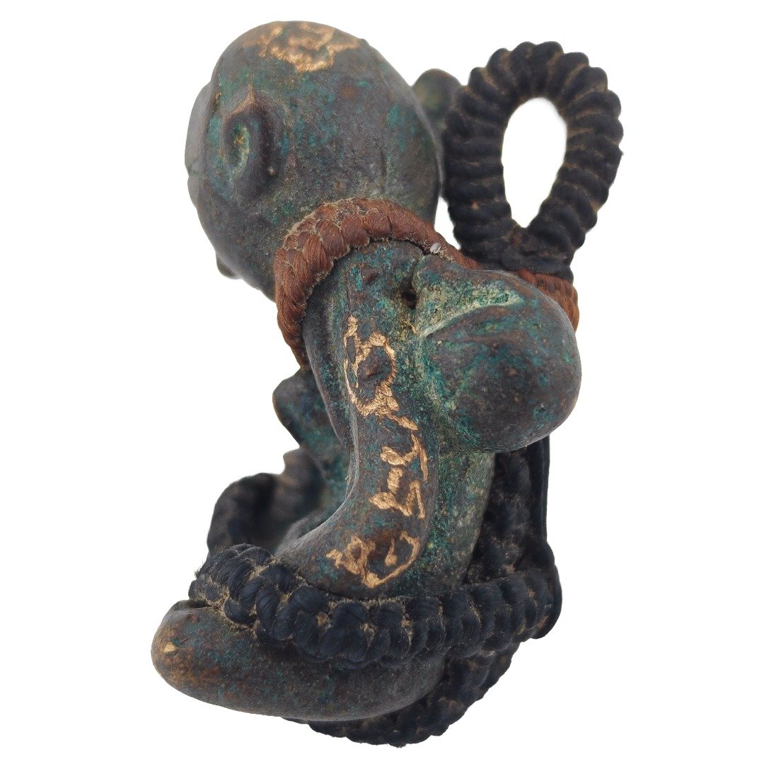 Side view of old Phra Upakut showing money bag aged Samrit patina and original braided cord
