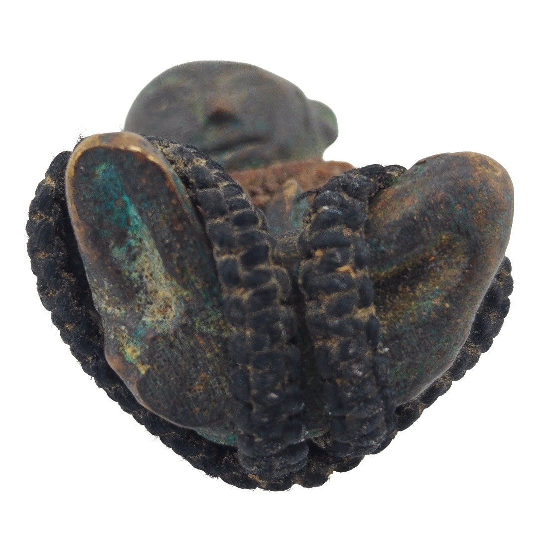Underside of old Samrit Phra Upakut showing natural patina oxidation and original braided cord