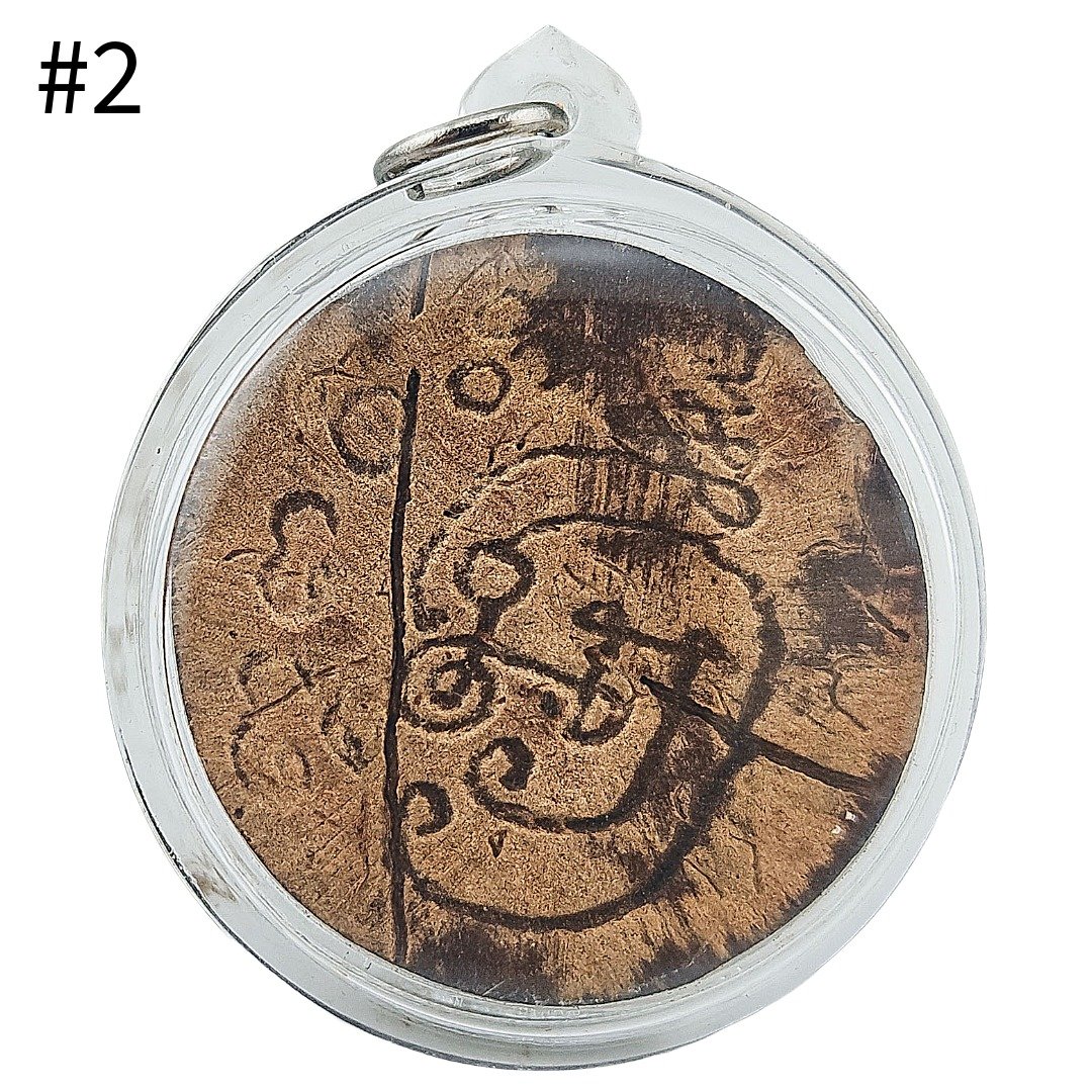 Back view of Phra Rahu amulet #2 showing hand-engraved Na Rahu on one-eye coconut shell