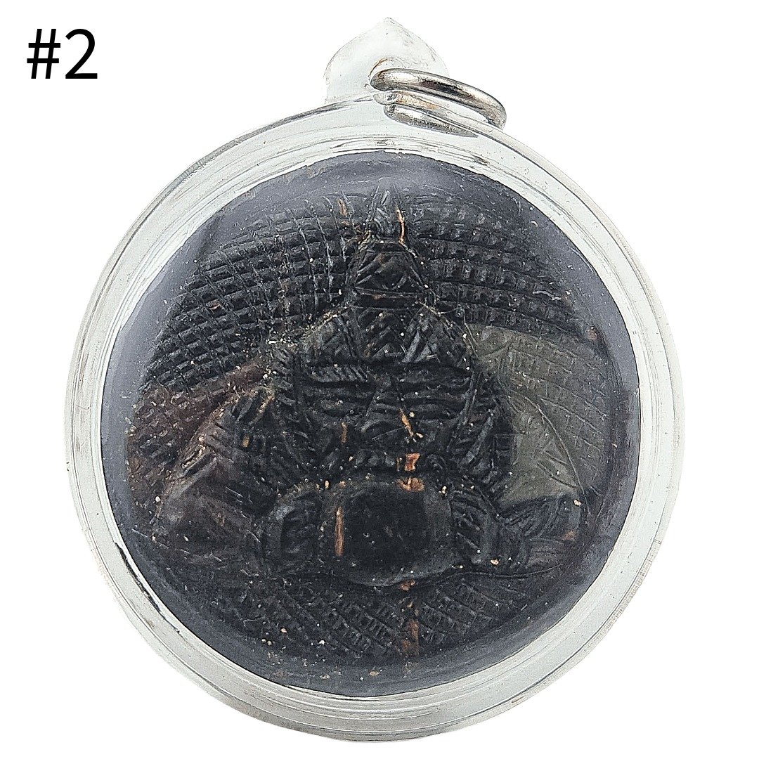 Front view of Phra Rahu one-eye coconut amulet #2 by Phu Lersi Pong