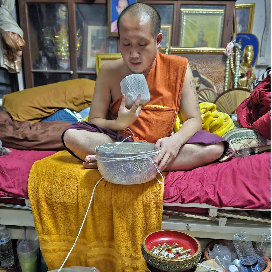 Phra Ajarn Dtutop blessing Takrut Noon Duang together with other sacred pieces at Wat Paphai, Chiang Rai
