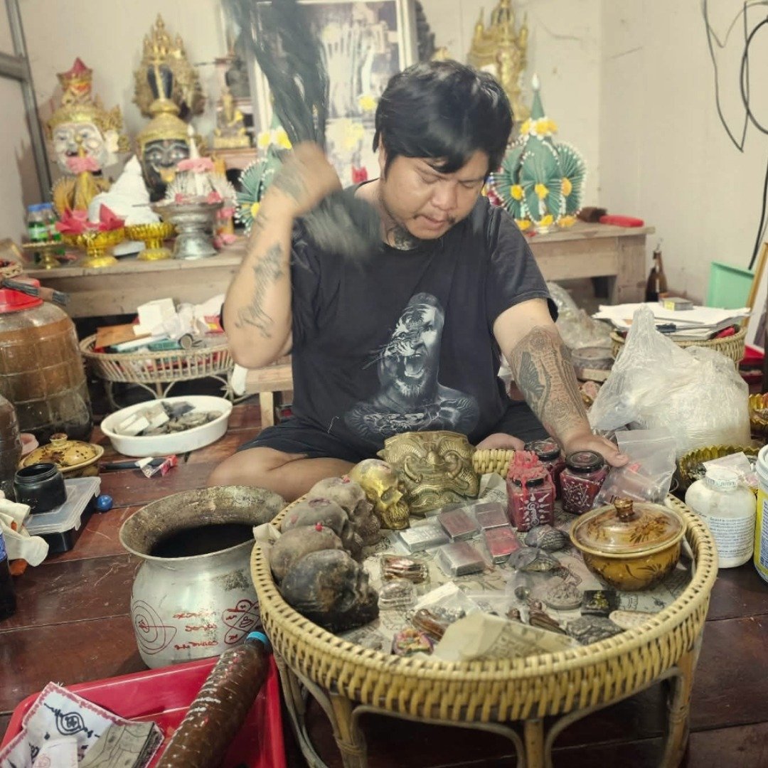 Ajarn Kitkamo blessing the 9 Ladies concentrated Nam Man Prai master mixture at his samnak