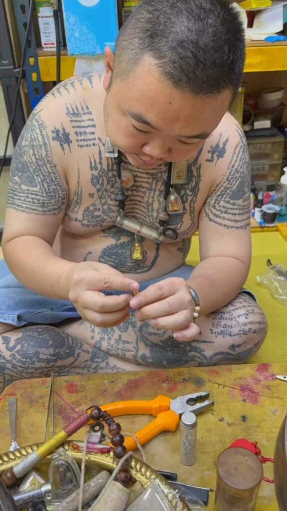 Phu Lersi Techo preparing sacred materials to be added to an individually made custom takrut