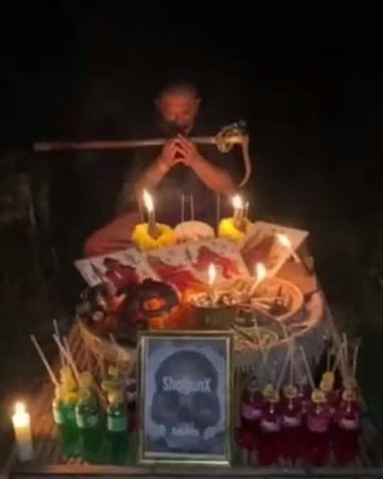 Ajarn Tom consecrating the Phaya Yom coffin wood Mai Yant at a cemetery.