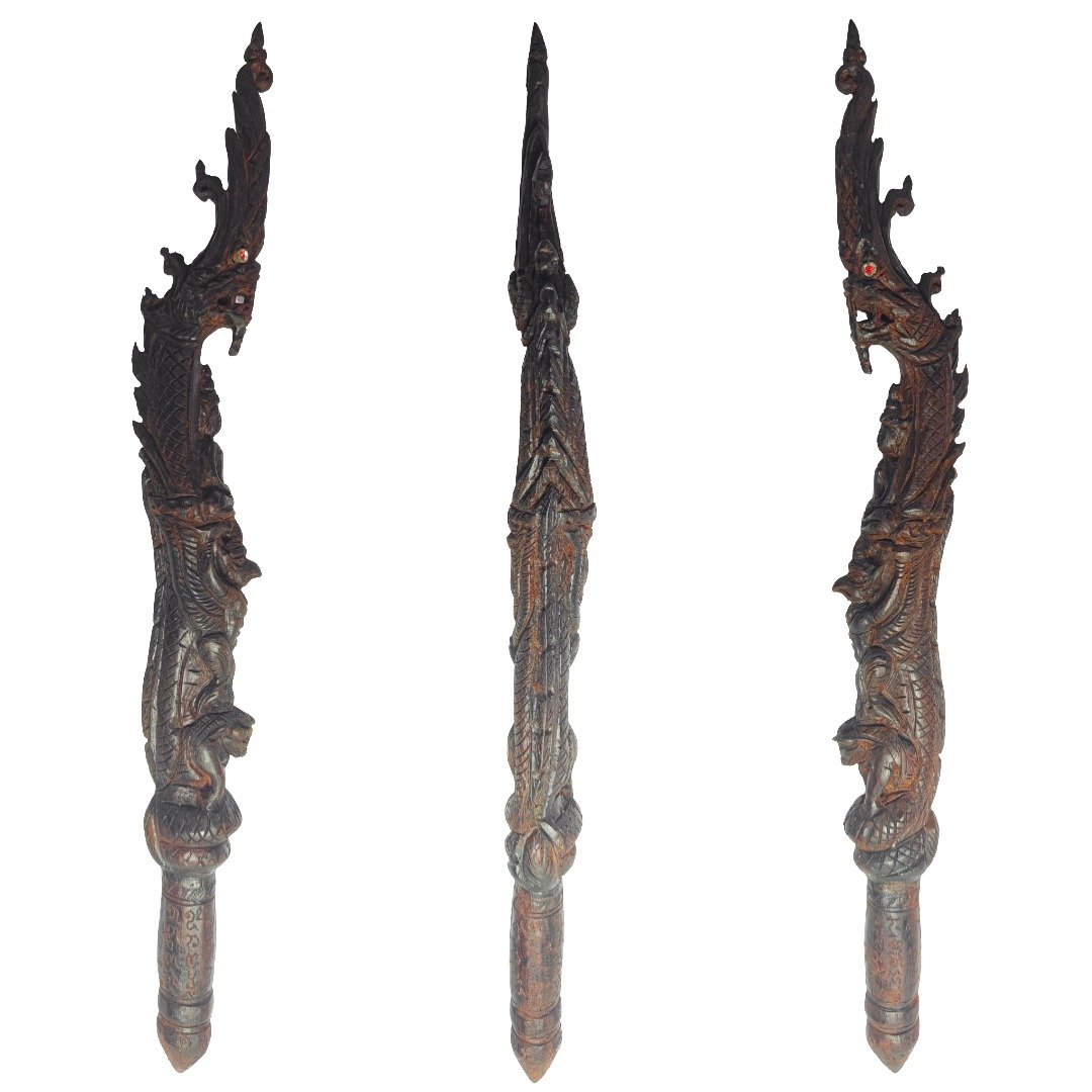 Full view of the Phaya Nak Mai Kru showing Naga, Buddha, Garuda and Wua Tanu carved into one wooden wand.