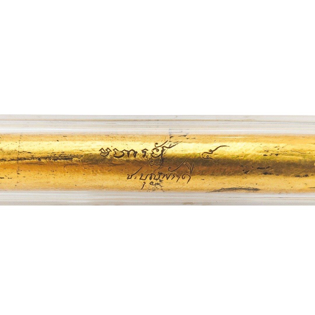 Close-up of Kruba Chokchai Takrut Maha Rangap showing hand-written yants over the gold-leaf exterior