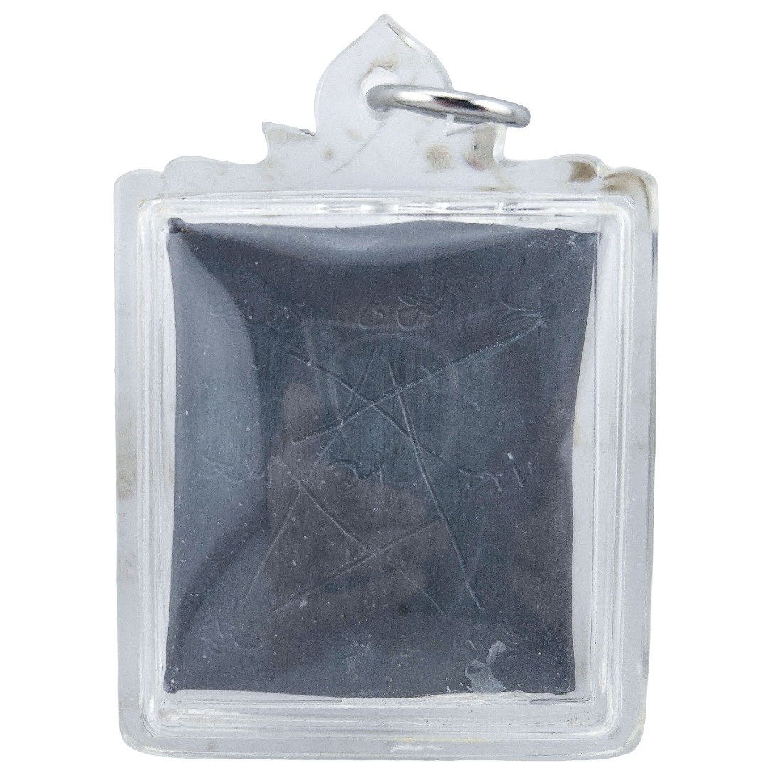 Prai John Wicca by Ajarn Kitkamo showing faint engraved ritual inscriptions on a Tagua takrut sheet inside a clear amulet casing.