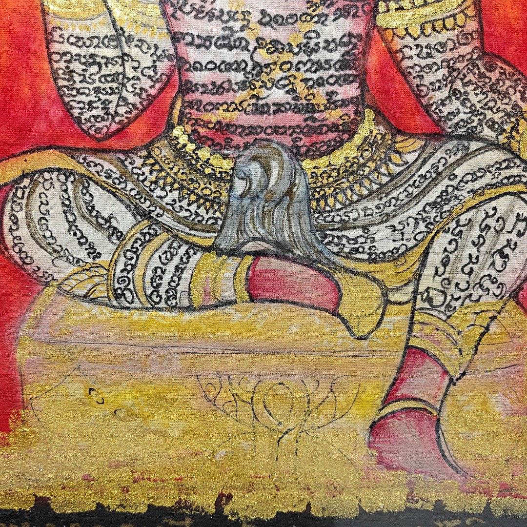Close-up of the hand-painted inscriptions, patterned clothing and gold-coloured details on Ajarn Tom's XL Phaya Yom phayant.