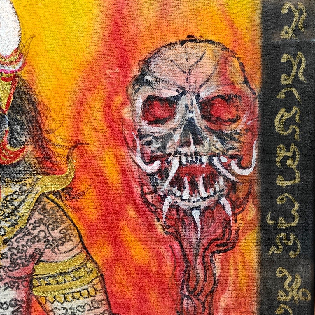Close-up of the skull-topped staff and surrounding inscriptions on Ajarn Tom's hand-painted Phaya Yom phayant.