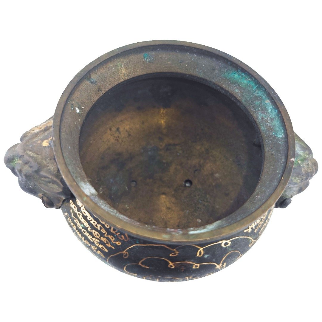 Top view showing the interior, aged metal surface and circular opening of the samrit incense urn