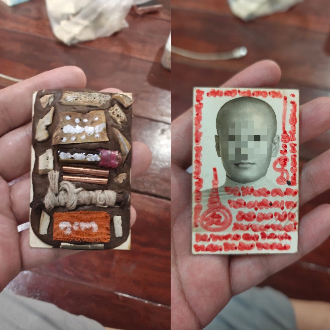 Front and back of the uncased Nameless Monk Prai, showing Ajarn Kitkamo's red yants and the arrangement of prai relics.