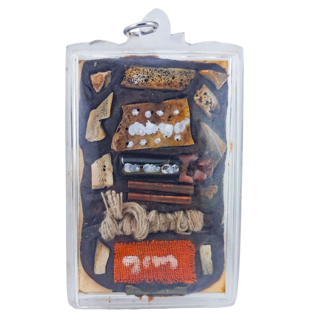 Back of the Nameless Monk Prai amulet showing the monk's panneng, Nam Man Prai bottle, takrut, Sai Sin and orange monk robe.