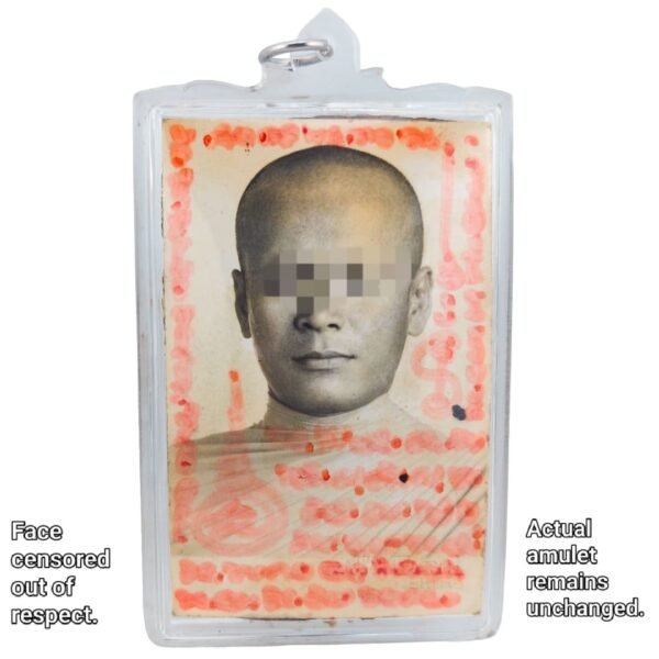 Front of the one-to-one Nameless Monk Prai amulet with the monk's portrait, red handwritten yants and face censored out of respect.
