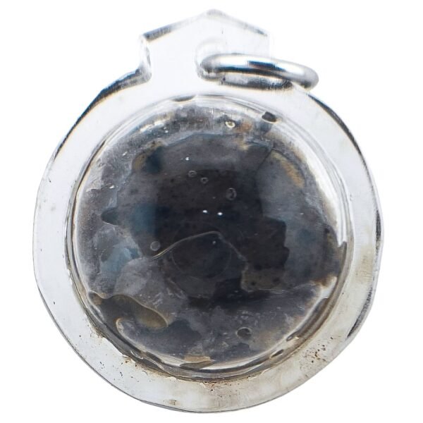 Front close-up of a Pure Hakom Wax Luk Om by Ajarn Tom, showing the dark concentrated Hakom Hua Chuea inside its clear round casing.