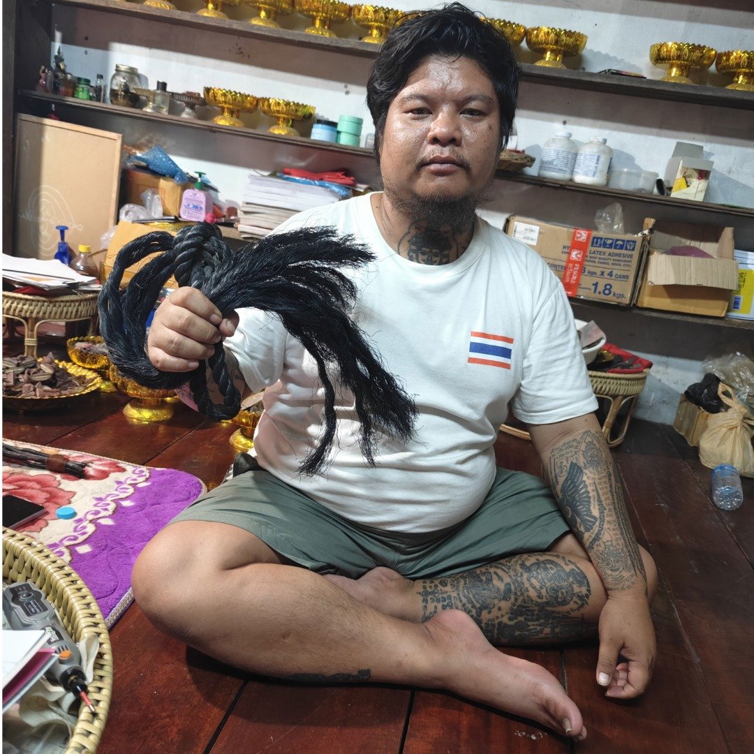 Ajarn Kitkamo holding his personal Prai Command Whip made from old corpse-recovery rope.