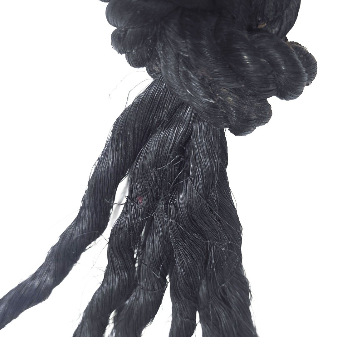 Close-up of the black rope strands and tightly knotted section of Ajarn Kitkamo's Prai Command Whip.