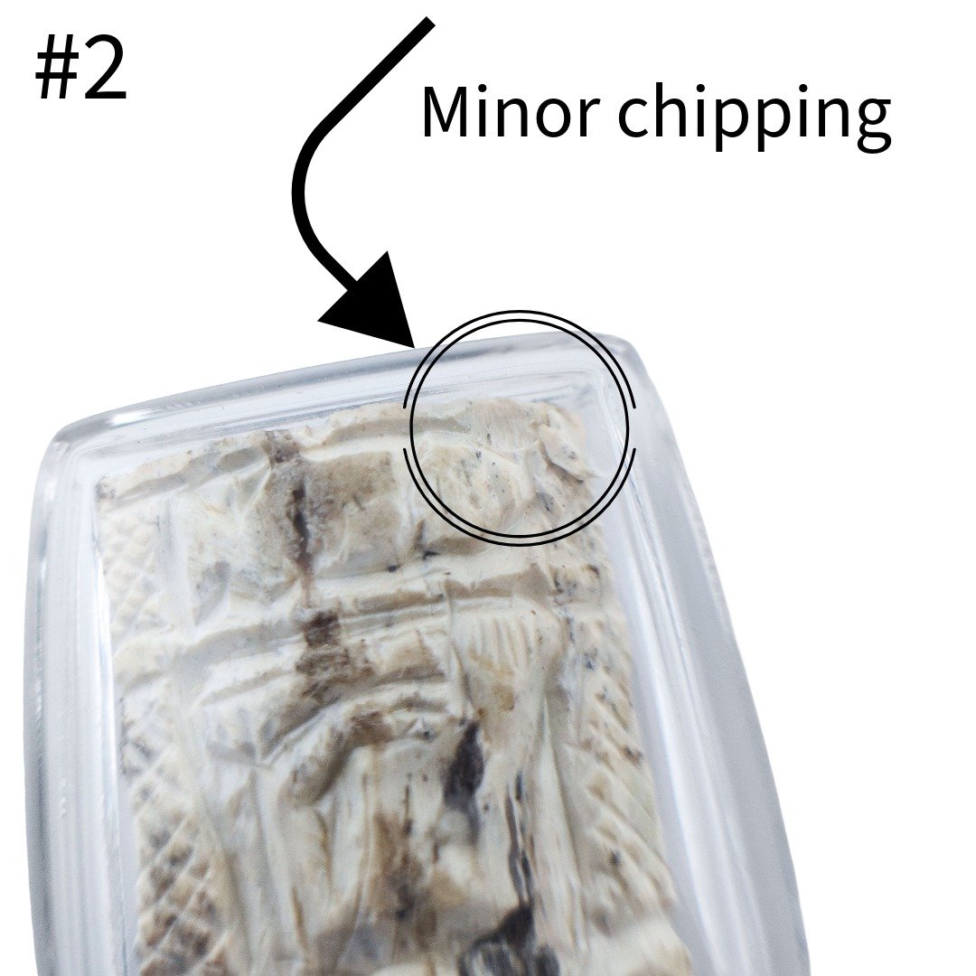 Close up of Gradook Prai Khun Paen piece 2 highlighting minor chipping near the upper edge of the amulet